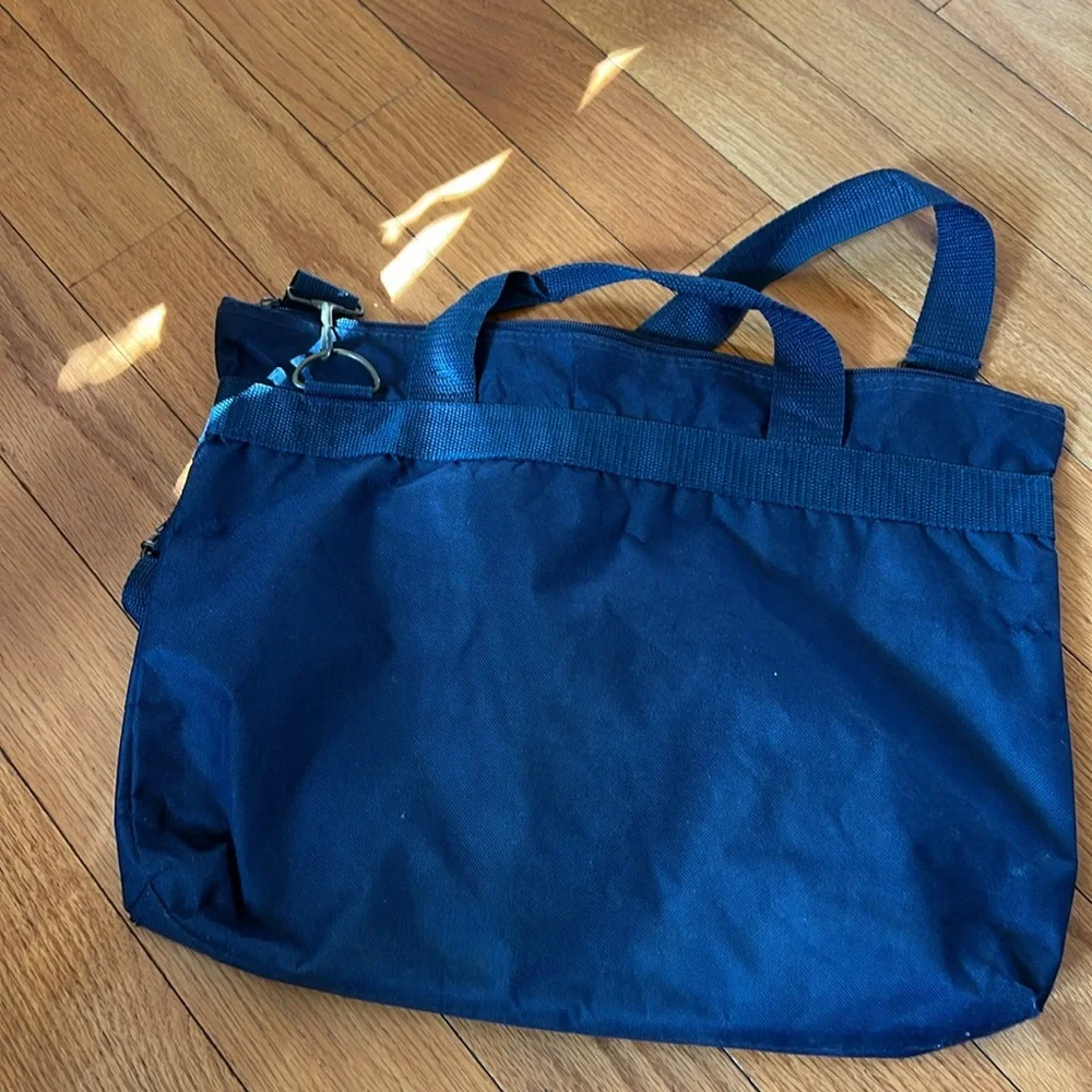 Navy laptop bag with 2 zipper pockets, hand straps and shoulder strap